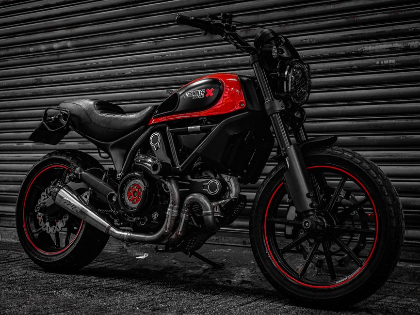 Stylish custom Ducati motorcycle parked in an urban setting in Ho Chi Minh City, Vietnam.